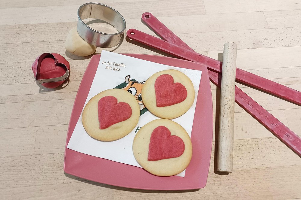 Kekse in Herzform auf einem rosa Teller 